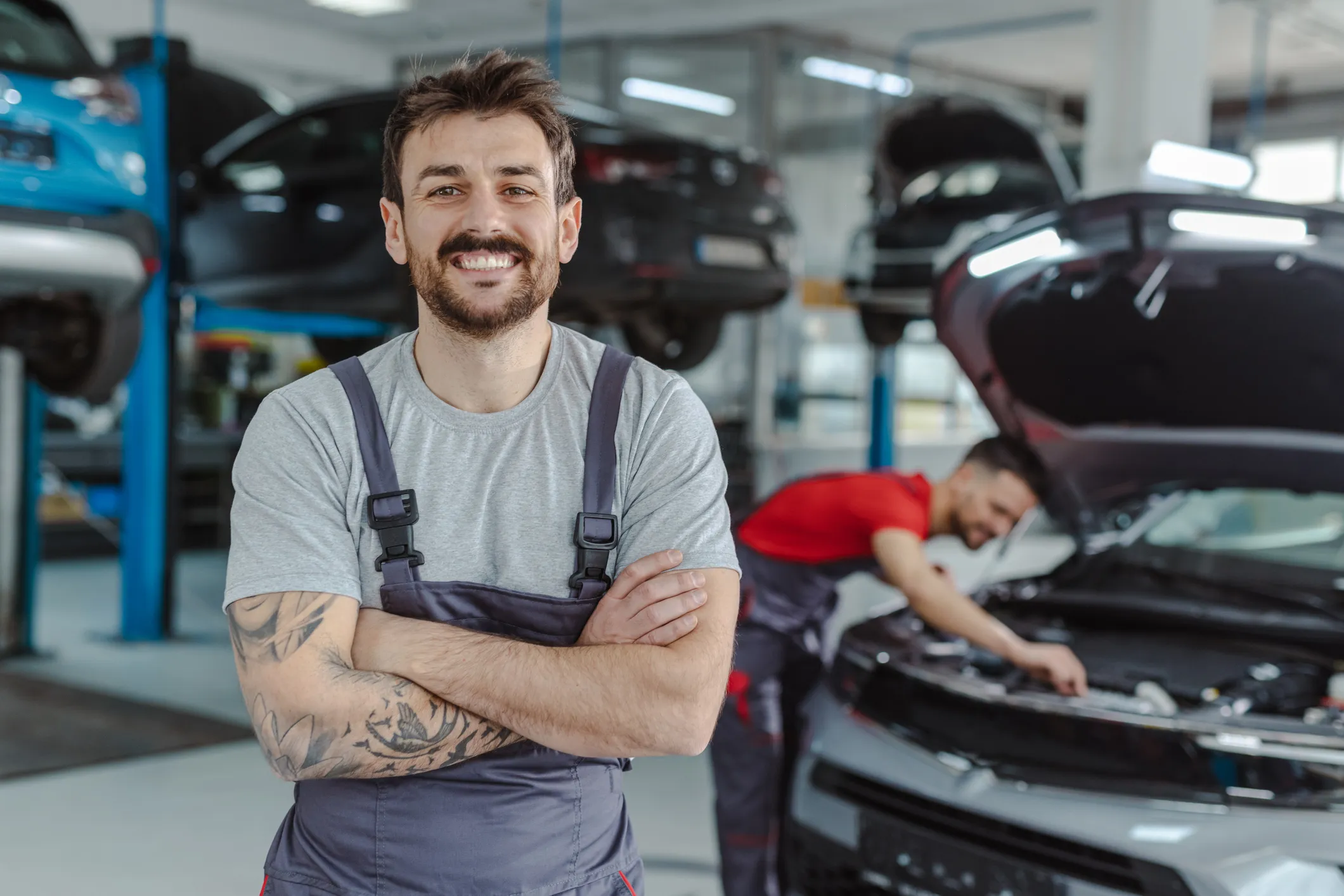 Monteur in einer Werkstatt erledigt Service Aufgaben an einem Auto